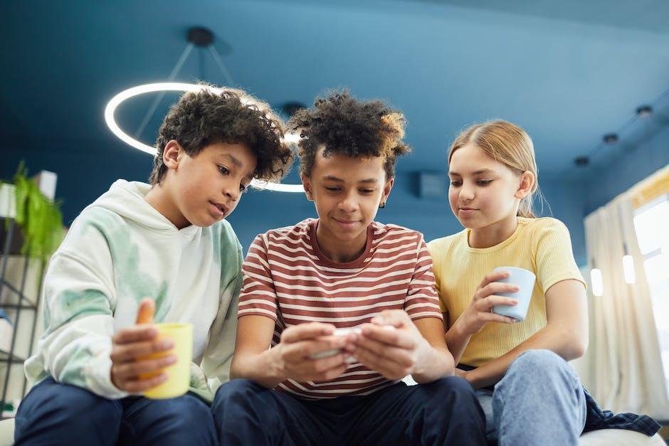A group of kids looking at a smartphone together